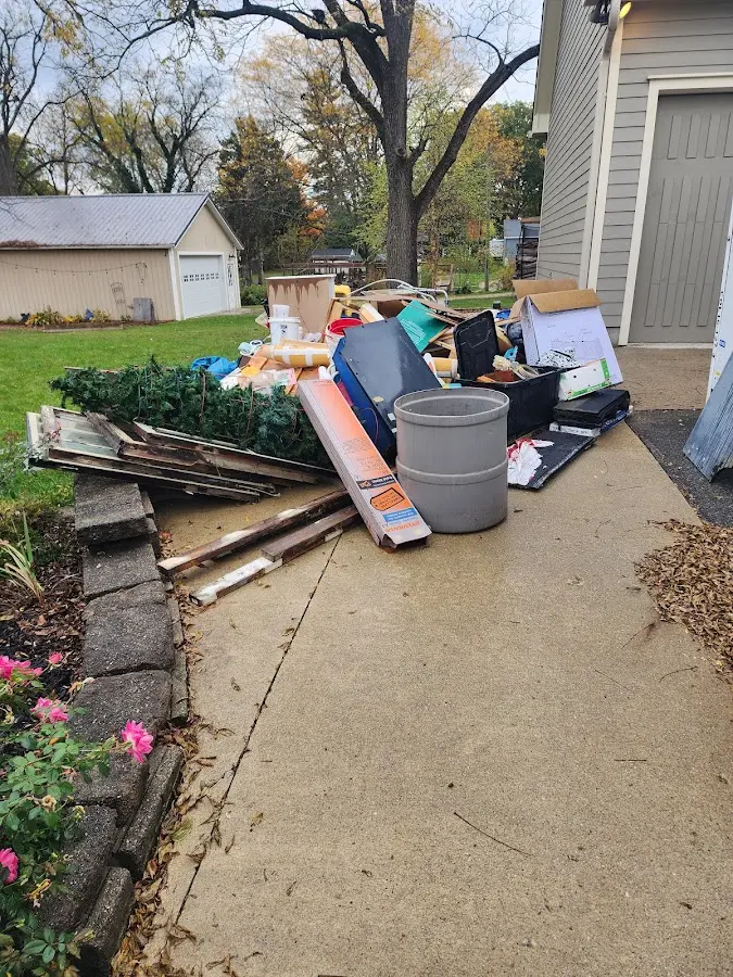 Dumpster being loaded with debris for 12 Yard Dumpster Rental in La Marque